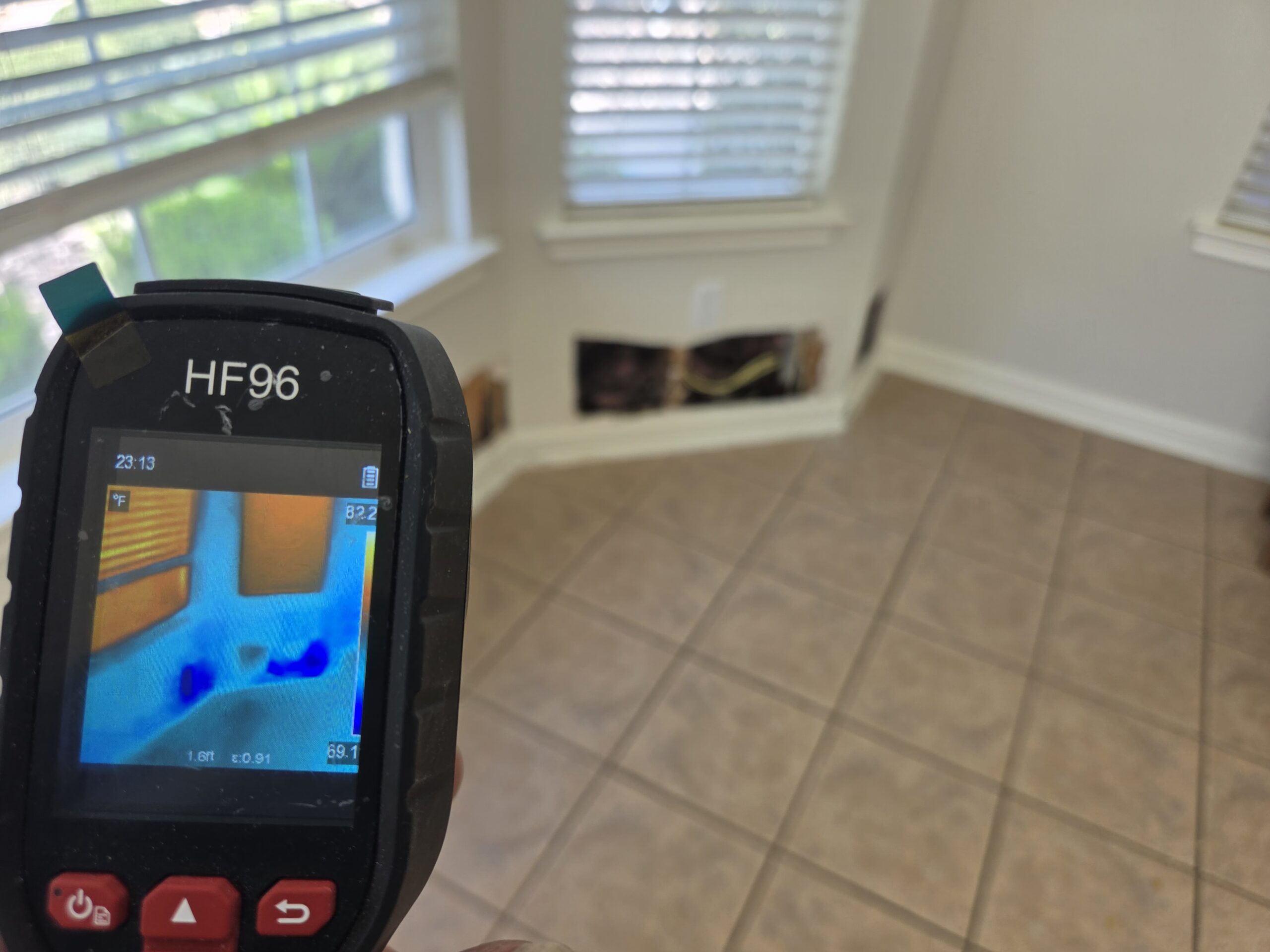 Restoration technician operating professional drying equipment inside a water-damaged Austin home