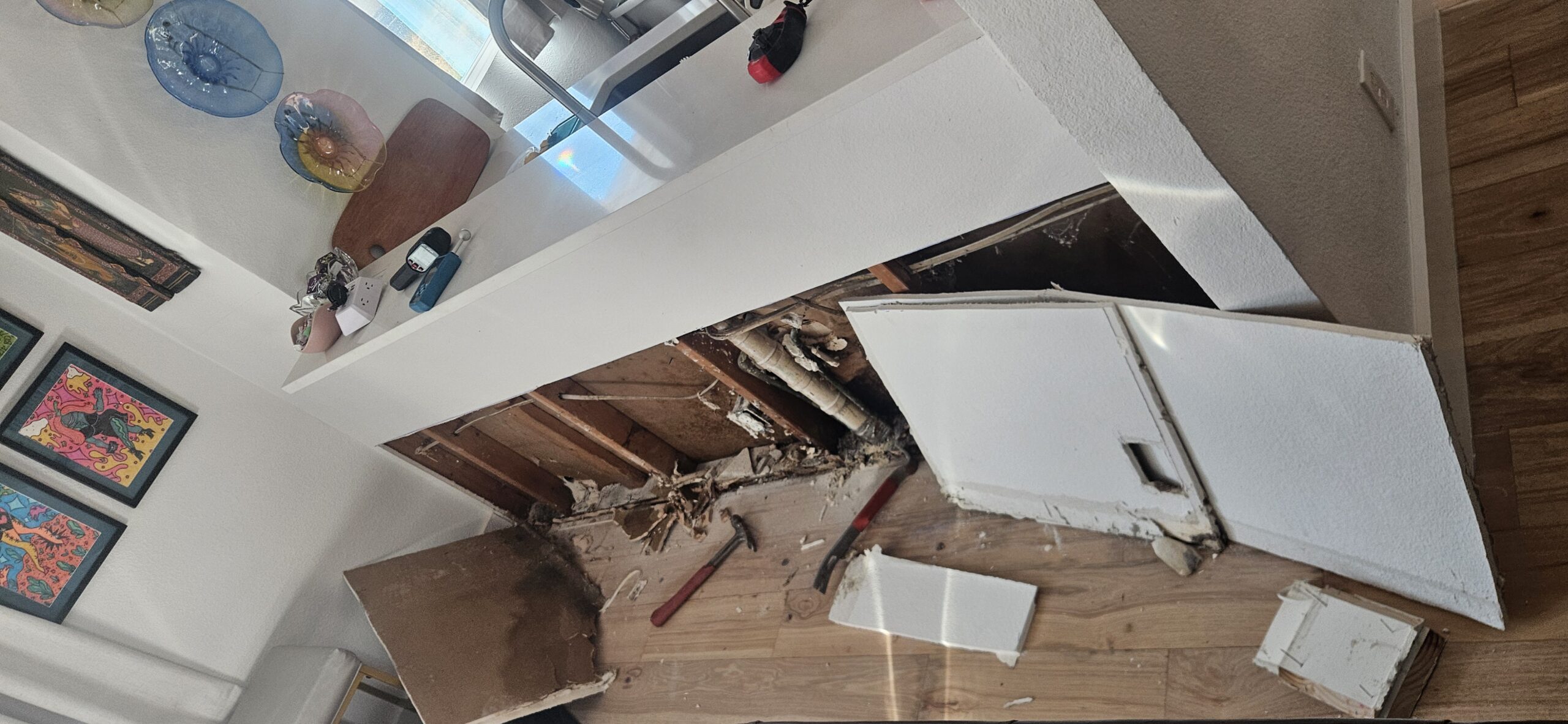Legacy Water Restoration technician inspecting water damage in an Austin home